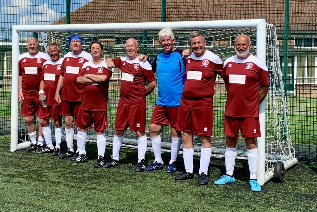 A group of football players posing for a photo

Description automatically generated with medium confidence